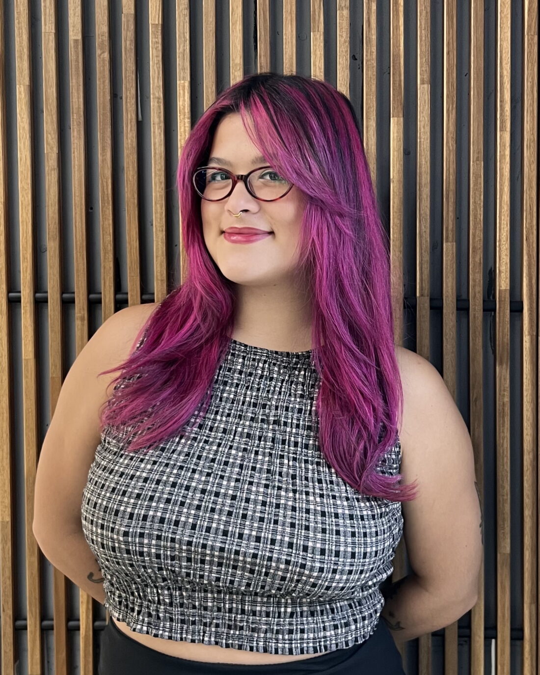 Emily in front of a wooden background.