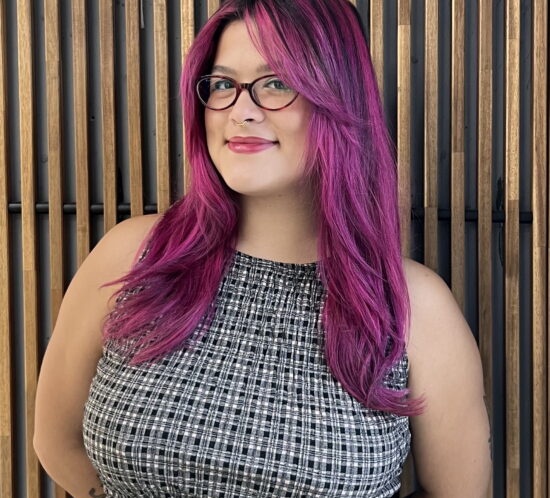 Emily in front of a wooden background.